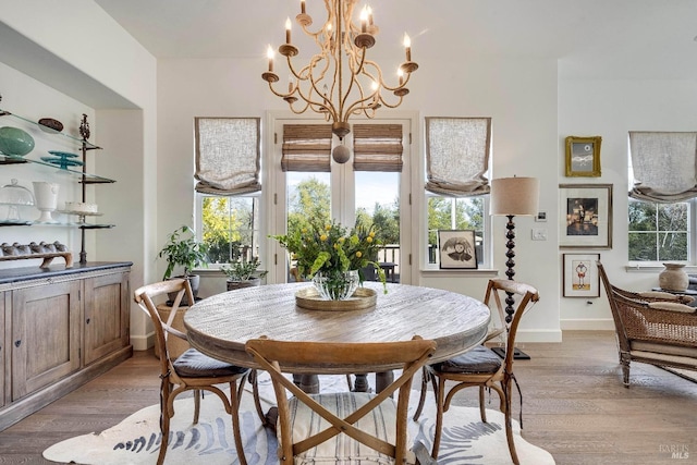 dining room featuring light wood finished floors and baseboards