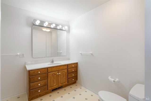 bathroom with vanity and toilet