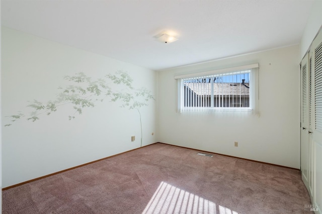 unfurnished bedroom featuring a closet and light carpet