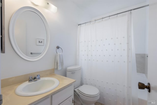 bathroom with vanity, curtained shower, and toilet