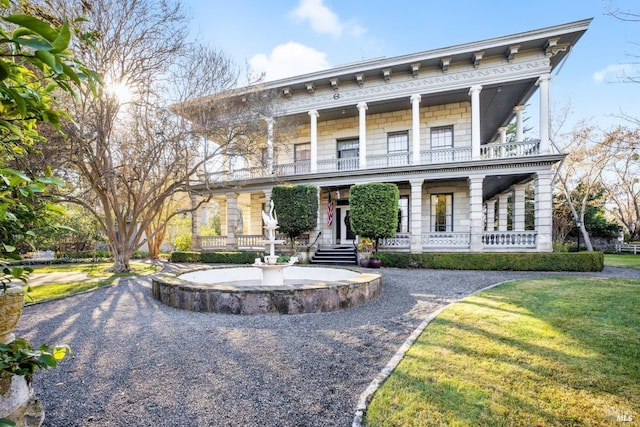 view of front of house featuring a balcony and covered porch