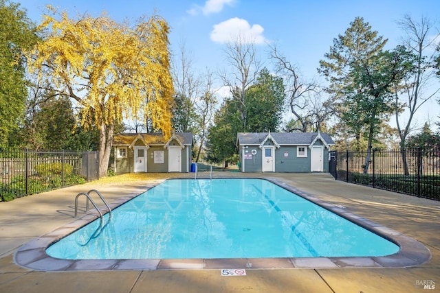 view of pool with an outdoor structure and a patio area