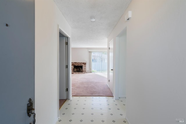 hallway with a textured ceiling