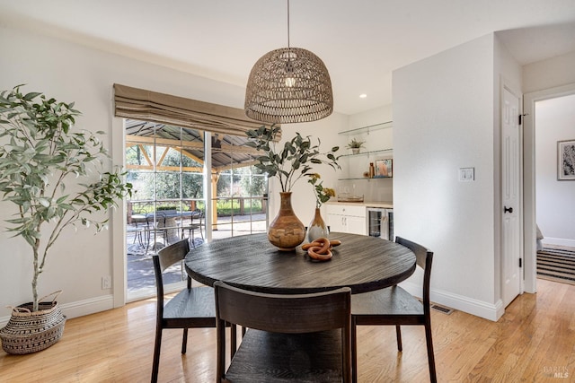 1077 Valley View St, Saint Helena, CA 94574 - dining room featuring light wood-style flooring, recessed lighting, bar area, and beverage cooler