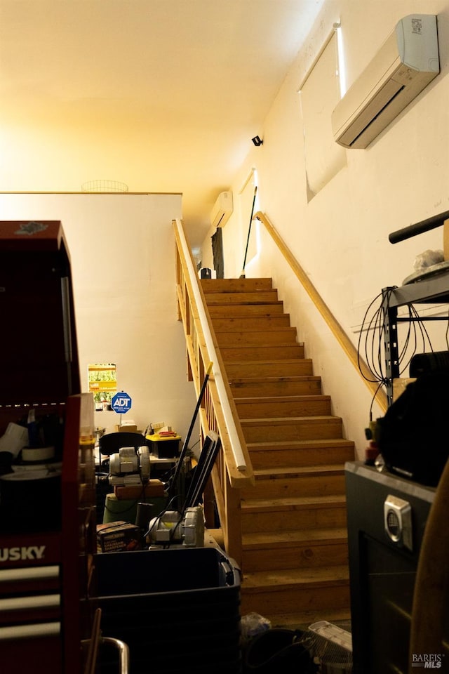 staircase featuring an AC wall unit