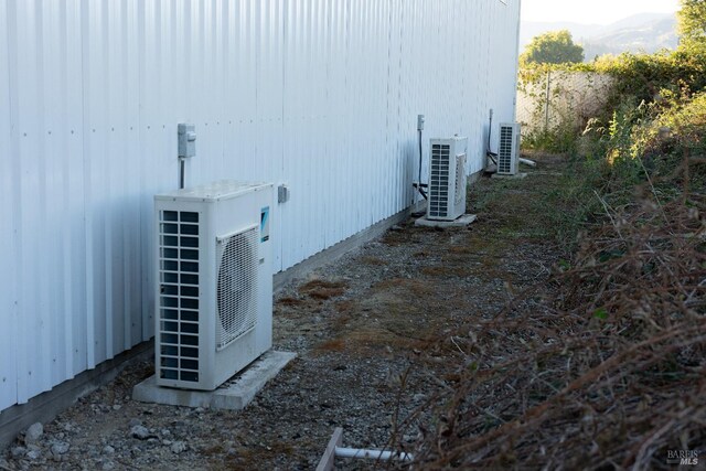 exterior details featuring ac unit, a mountain view, and central AC