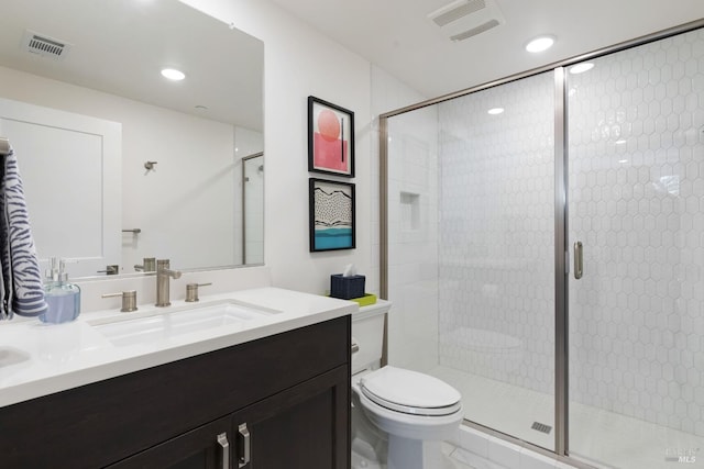 bathroom with vanity, an enclosed shower, and toilet