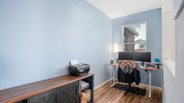 office space featuring light wood-style floors and baseboards