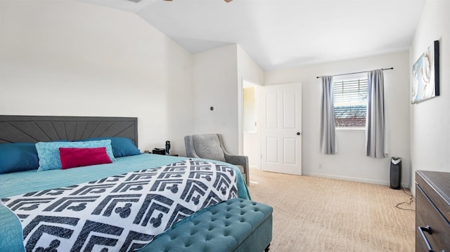 carpeted bedroom featuring baseboards and lofted ceiling