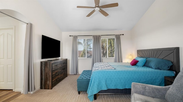 carpeted bedroom with vaulted ceiling and ceiling fan