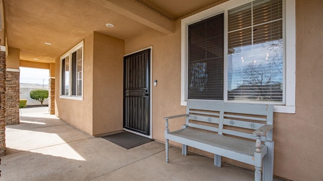 view of exterior entry with stucco siding