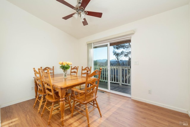 dining area featuring visible vents, a ceiling fan, light wood-style flooring, and baseboards