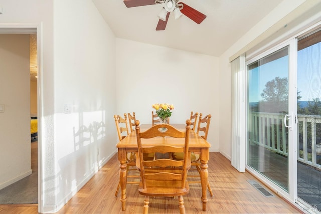 dining area featuring light wood-type flooring, baseboards, visible vents, and a ceiling fan