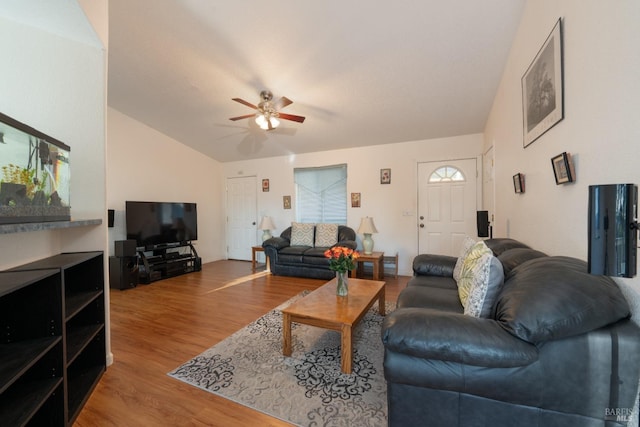 living area featuring lofted ceiling, ceiling fan, and wood finished floors