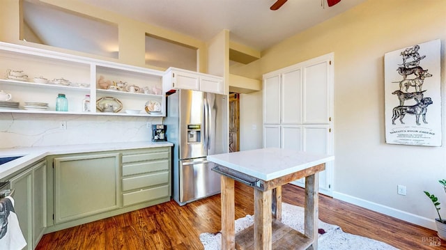 kitchen with white cabinetry, open shelves, stainless steel refrigerator with ice dispenser, dark wood finished floors, and green cabinetry