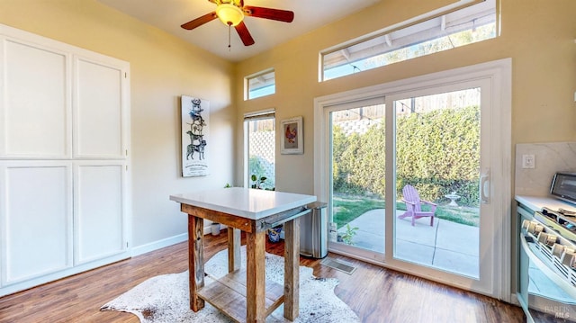 dining space featuring baseboards, visible vents, light wood-type flooring, and a ceiling fan