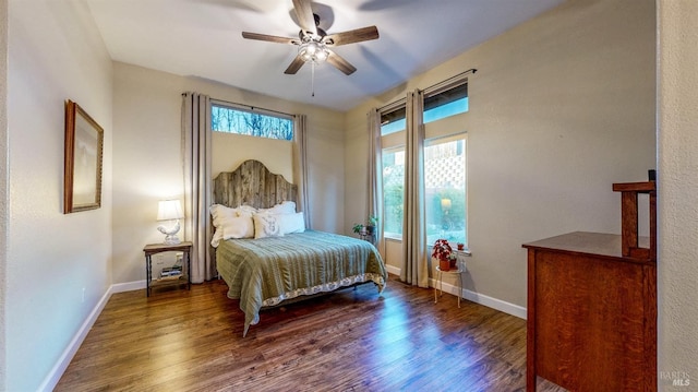 bedroom with dark hardwood / wood-style floors and ceiling fan