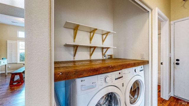 laundry area with separate washer and dryer and dark wood-type flooring