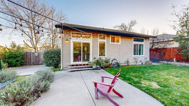 back of house with a patio area, entry steps, fence, and a lawn