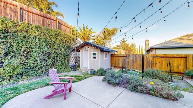 view of patio featuring a storage shed, a fenced backyard, and an outdoor structure