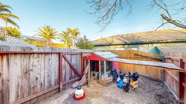 exterior space featuring an outdoor structure and fence