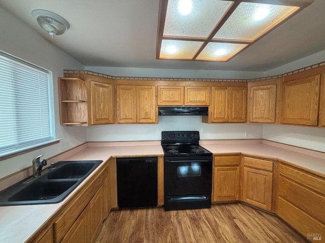 kitchen with extractor fan, sink, light wood-type flooring, and black appliances