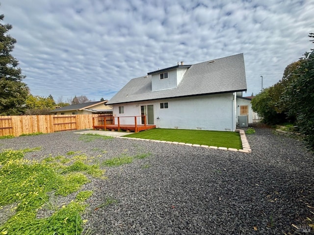 back of house featuring a wooden deck, a yard, and cooling unit