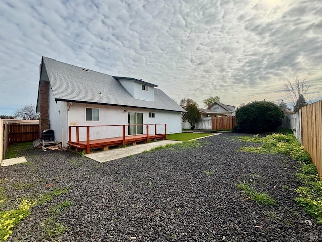 back of house with a wooden deck