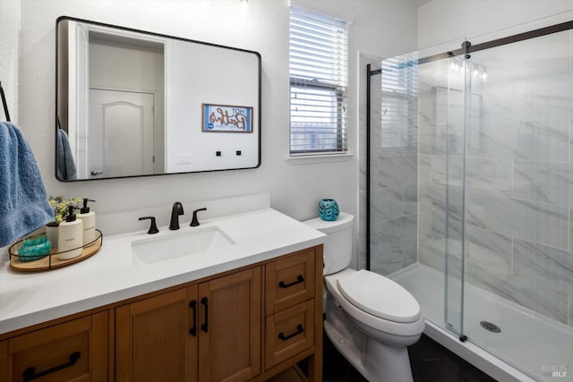 bathroom with vanity, toilet, and walk in shower