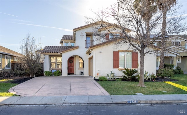 mediterranean / spanish-style home with a front yard