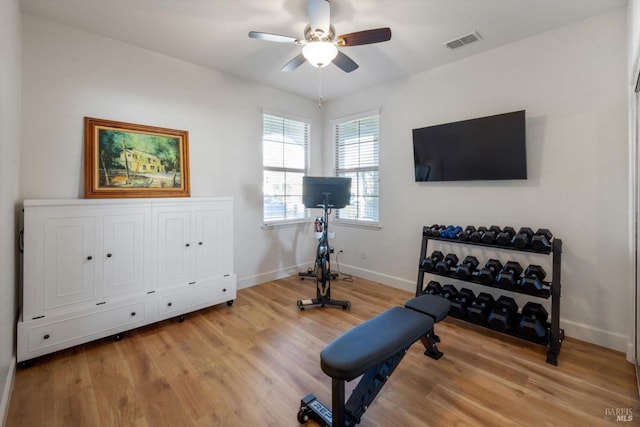 exercise area with ceiling fan and wood-type flooring