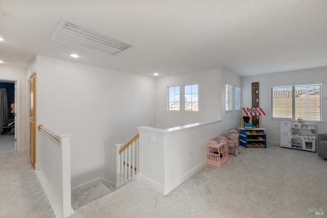 game room featuring plenty of natural light and light carpet