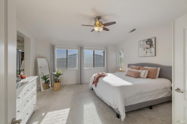 carpeted bedroom with multiple windows, vaulted ceiling, and ceiling fan