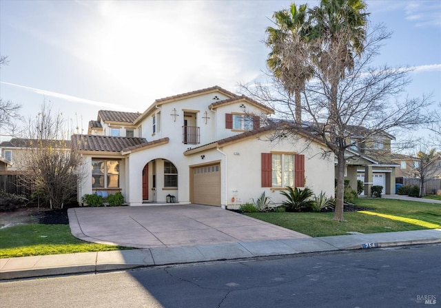 mediterranean / spanish-style house with a garage and a front yard