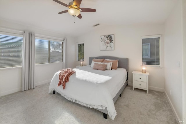 bedroom with vaulted ceiling, light colored carpet, and ceiling fan