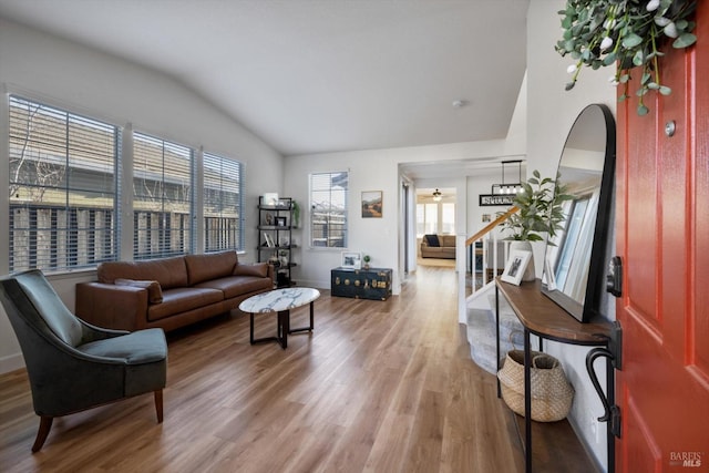 living room featuring lofted ceiling and hardwood / wood-style floors