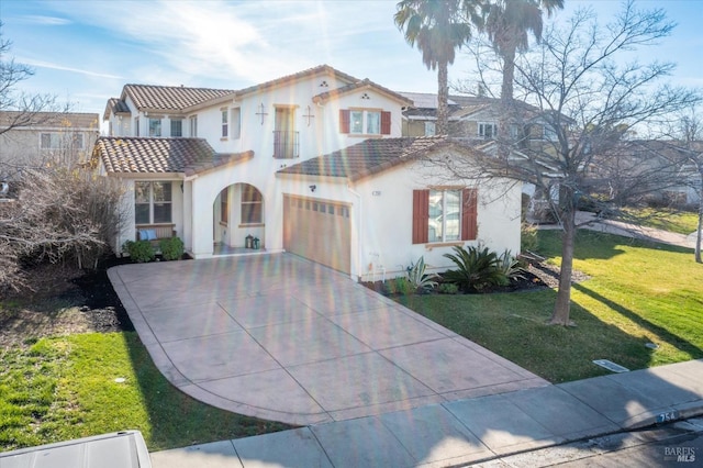 mediterranean / spanish home with a garage and a front yard