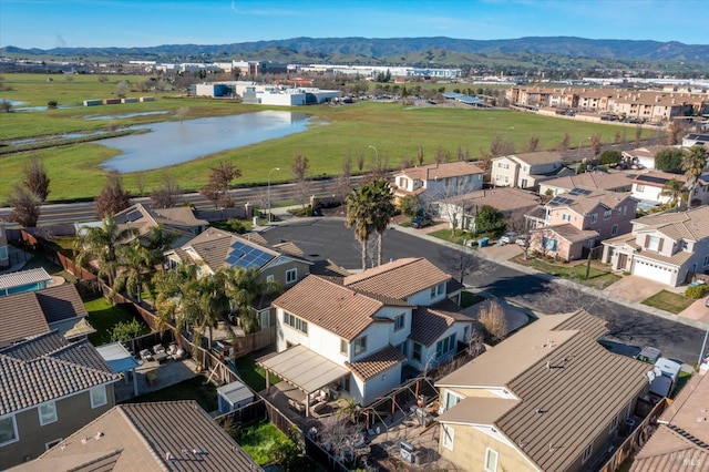 drone / aerial view featuring a water and mountain view