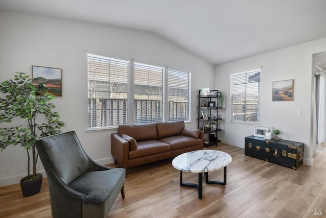 living room with vaulted ceiling and light hardwood / wood-style floors