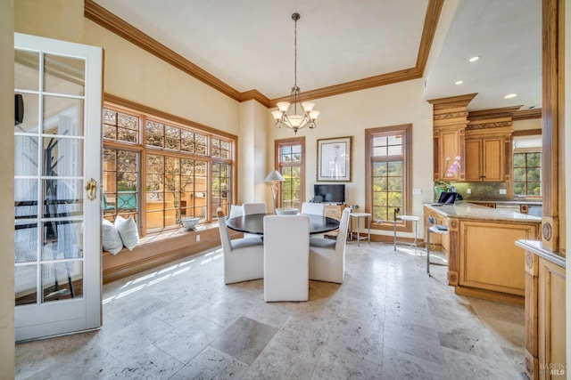 dining area featuring ornamental molding and a chandelier