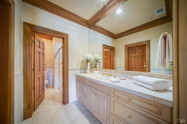 bathroom featuring vanity, tile patterned flooring, crown molding, and toilet