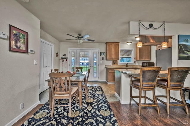 dining room featuring ceiling fan, baseboards, dark wood finished floors, and french doors