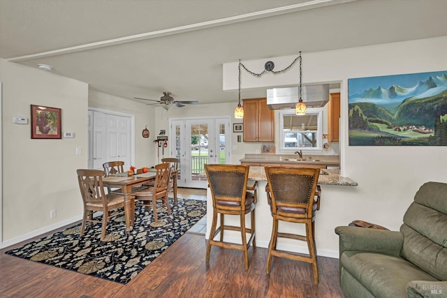 dining space featuring dark wood-style floors, french doors, and baseboards