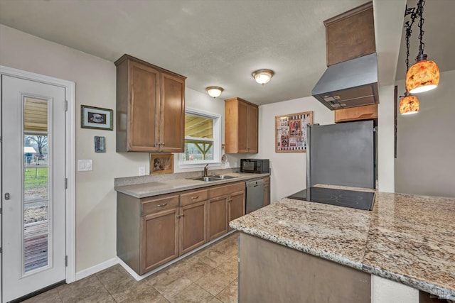 kitchen with light stone counters, island exhaust hood, hanging light fixtures, a sink, and black appliances