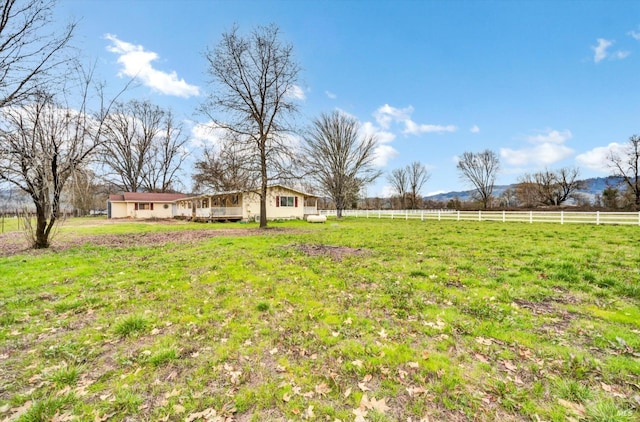 view of yard featuring a rural view and fence