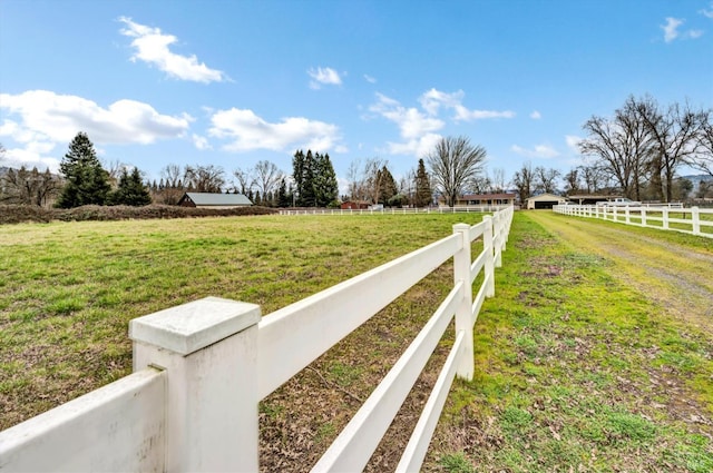 view of yard featuring a rural view and fence