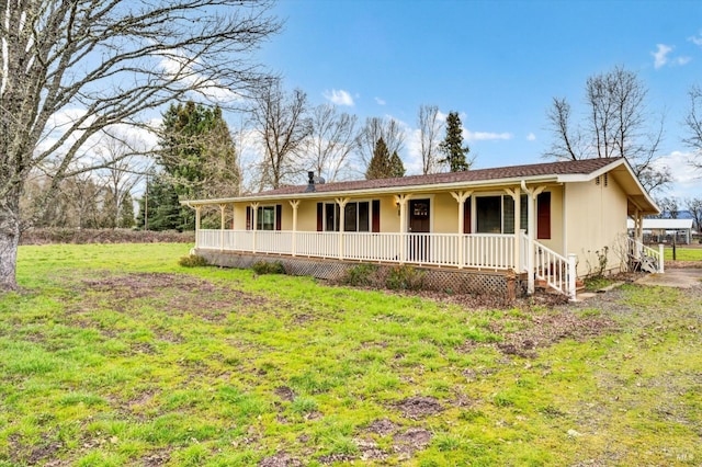 ranch-style home featuring a porch and a front lawn