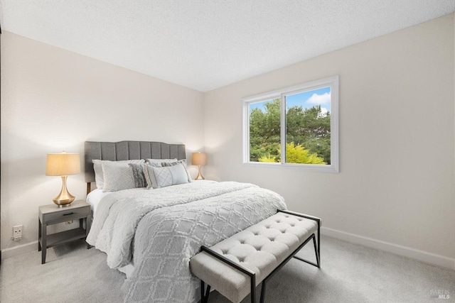 carpeted bedroom featuring a textured ceiling