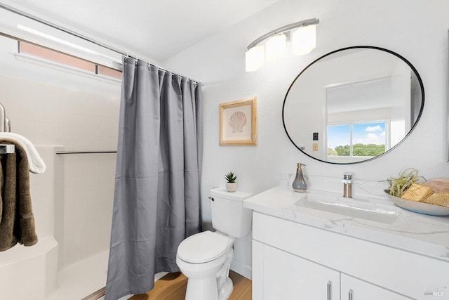 bathroom featuring vanity, curtained shower, toilet, and hardwood / wood-style flooring