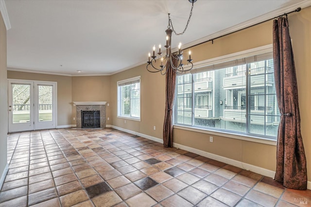 unfurnished living room with a chandelier, ornamental molding, a tiled fireplace, and light tile patterned floors